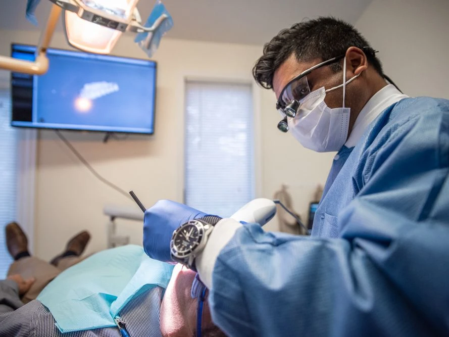 dr. bre patel doing a tooth extraction